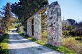 Ruins of an old stone bridge abutments nearby a road Royalty Free Stock Photo