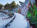 Ruins of Olympic bobsled track in Sarajevo with kids sledding