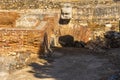 Ruins of a Roman system of running water and sewers with ancient Roman geometric frescoes between its brick walls of the Mitreo Royalty Free Stock Photo