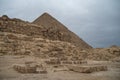 Ruins of the small pyramid of Queen Henutsen with Cheops Pyramid at background, Giza Plateau, Egypt. UNESCO World Heritage Royalty Free Stock Photo