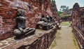 Ruins of stupa and statue of Buddha in Wat Mahathat, the ancient Thai temple in Ayutthaya Historical Park.