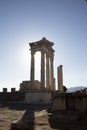 Ruins of the Temple of Trajan the ancient site of Pergamon. Izmir, Turkey. Ancient city columns with the sun in the background. Royalty Free Stock Photo