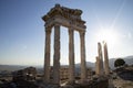 Ruins of the Temple of Trajan the ancient site of Pergamon. Izmir, Turkey. Ancient city columns with the sun in the background. Royalty Free Stock Photo