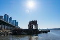 Ruins of the 69th Street Transfer Bridge in the Hudson River with Modern Glass Skyscrapers in the Lincoln Square New York City Sky