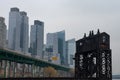 Ruins of the 69th Street Transfer Bridge in the Hudson River with Modern Glass Skyscrapers in the Lincoln Square New York City Sky