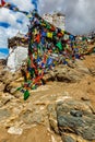 Ruins of Tsemo Victory Fort on the cliff of Namgyal hill and Lungta - colorful Buddhist prayer flags