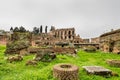 Ruins view of the Roman Forum in Rome, Italy on a cloudy day with green grass and ruins details in the foreground. Top view. Royalty Free Stock Photo