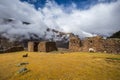 Ruins of the village of Pumamarka (Puma Marka) and llamas. Peru Royalty Free Stock Photo