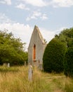 Ruins of church wall with arched window in grave yard. Concept of belief lasting through time.