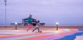 The ruins of West Pier, Brighton, East Sussex, UK. In the foreground, blurred children playing and running. Photographed at dusk Royalty Free Stock Photo