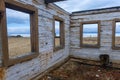 The ruins of a wooden house on the sandy beach