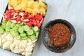 Rujak Buah, Sliced Indonesian Fruit Salad, Served with Spicy Brown Sugar sauce and Ground Peanuts. White Background, Selected Royalty Free Stock Photo