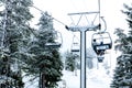 Ruka, Finland - November 24, 2012: Skiers are sitting on the chair ski lift at Ruka ski resort in freezing day