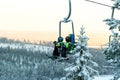 Ruka, Finland - November 27, 2012: Skiers are sitting on the chair ski lift at Ruka ski resort in freezing day