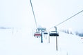 Ruka, Finland - November 24, 2012: Skiers sitting on the chair ski lift at Ruka ski resort in freezing day