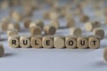 Rule out - cube with letters, sign with wooden cubes