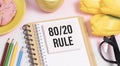 80 20 rule text on white paper on a table against