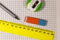 Ruler, pencil, sharpener and eraser on notepad sheet Royalty Free Stock Photo