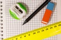 Ruler, pencil, sharpener and eraser on notepad sheet Royalty Free Stock Photo