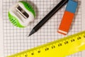 Ruler, pencil, sharpener and eraser on notepad sheet Royalty Free Stock Photo