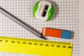 Ruler, pencil, sharpener and eraser on notepad sheet Royalty Free Stock Photo