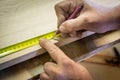 Ruler and pencil on a wooden background. Part marking. Carpenter`s workshop. Work carpenter. Royalty Free Stock Photo