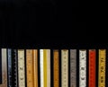 A straight line of rulers and scales in metric and inches suggest measurement, metrics, precision, accuracy