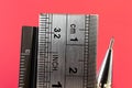 Rulers and mechanical pencil macro image in red background. Royalty Free Stock Photo