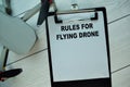 Rules For Flying Drone write on a paperwork isolated on Wooden Table