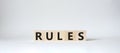 Rules symbol. Wooden cubes with word Rules. Beautiful white background. Rules concept. Copy space Royalty Free Stock Photo