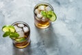 Rum and cola. Cuba Libre drink with lime and ice on rustic concrete table Royalty Free Stock Photo