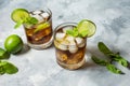 Rum and cola. Cuba Libre drink with lime and ice on rustic concrete table Royalty Free Stock Photo