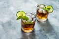 Rum and cola. Cuba Libre drink with lime and ice on rustic concrete table Royalty Free Stock Photo