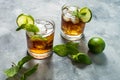 Rum and cola. Cuba Libre drink with lime and ice on rustic concrete table Royalty Free Stock Photo