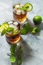 Rum and cola. Cuba Libre drink with lime and ice on rustic concrete table Royalty Free Stock Photo