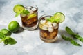 Rum and cola. Cuba Libre drink with lime and ice on rustic concrete table Royalty Free Stock Photo