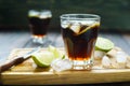 Rum and cola refreshing Cuba Libre alcohol cocktail with lime an