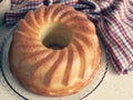 Rum-soaked circular cake Savarin. Freshly-baked rum baba. Yeasted cake baked in a ring mold Royalty Free Stock Photo