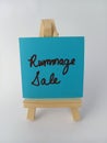 Rummage sale sign on a wood easel on a white background