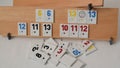 Rummy game formations arranged on the board in selective focus. Wooden board with sets of numbers Royalty Free Stock Photo