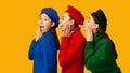 Three Multiethnic Gossip Girls Whispering Secrets Over Yellow Background, Panorama