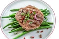 Rump Steak with Green vegetable,French beans, pepper close up on plate Royalty Free Stock Photo