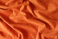 Rumpled reddish orange artificial suede fabric