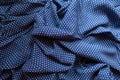 Rumpled fabric in blue and white with polka dot print