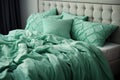 Rumpled mint-colored bed on the bed