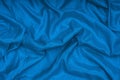 Rumpled silk blue fabric texture. Classic blue background