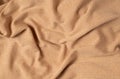 Rumpled simple beige cotton jersey fabric top view