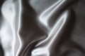 Rumpled glossy gray polyester satin fabric