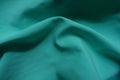 Rumpled thin bluish green chiffon fabric