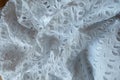 Rumpled white eyelet embroidery cotton fabric